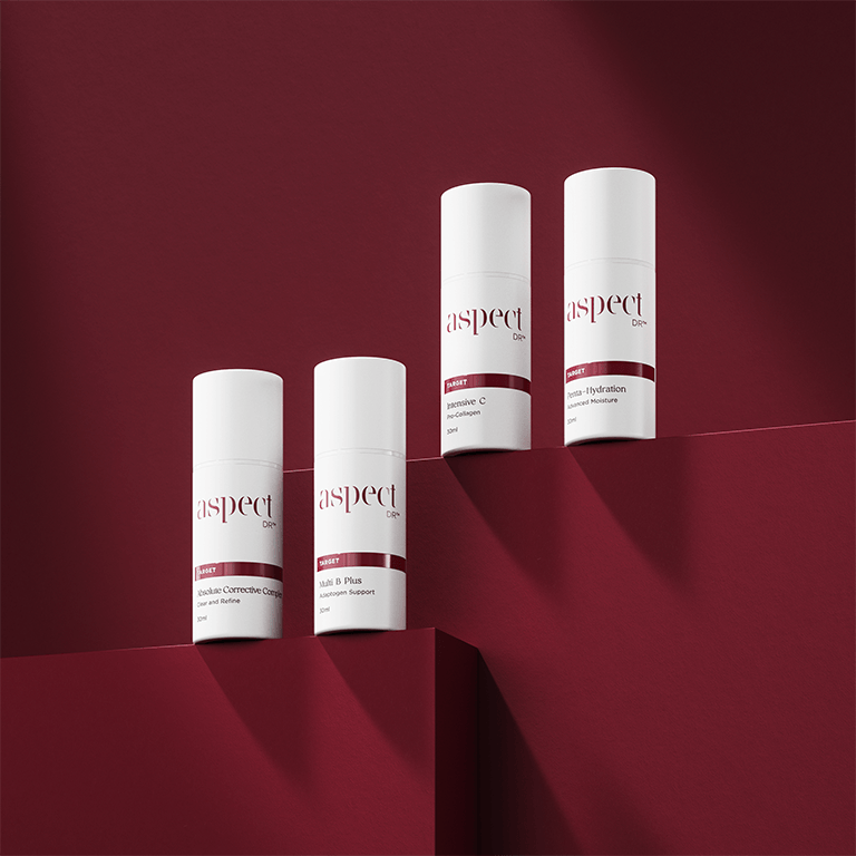 Aspect Dr target serums photographed on the brand's signature burgundy